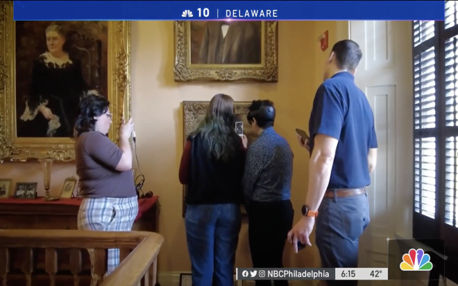 Image of students looking at a painting with new technology from NBC10