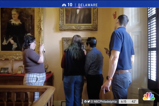 Image of students looking at a painting with new technology from NBC10